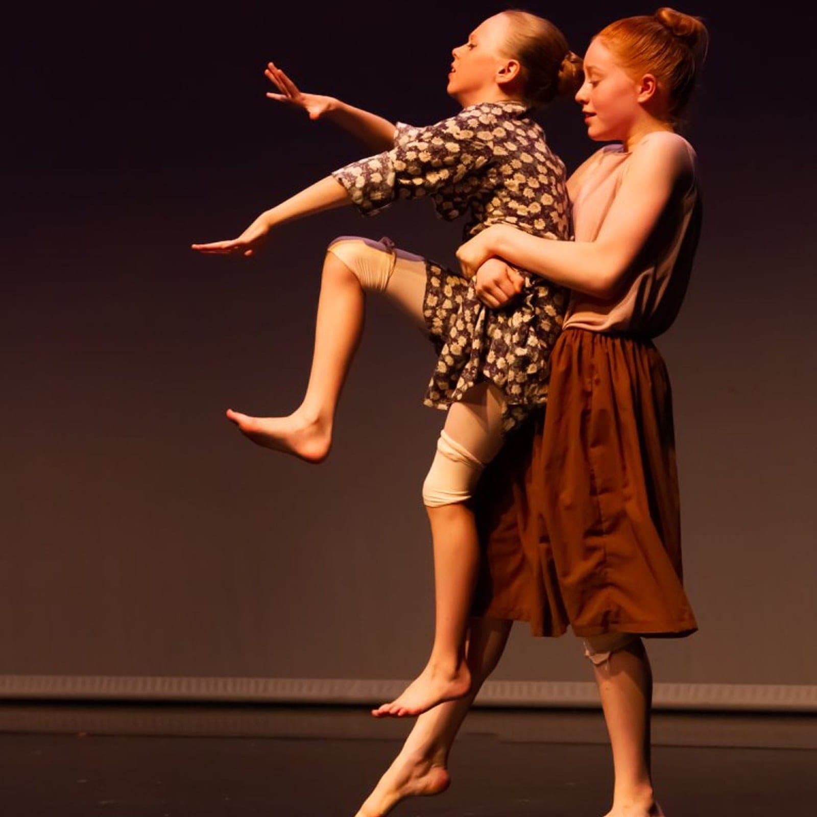 Two contemporary dancers in a dramatic lift